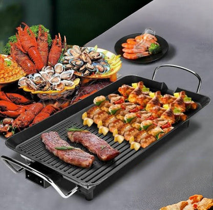 Electric non stick smokeless BBQ grill pan with large rectangular cooking surface.