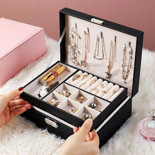 Large capacity travel jewelry organizer made from PU leather with snap lock closure and removable storage dividers.