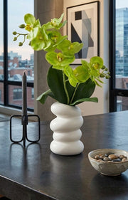 Artificial orchid flowers in a plastic vase measuring 28 cm tall, decorative floral arrangement for home or office. 