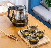 5-piece transparent heat-resistant glass infuser tea set with black accents, including one 1000ml kettle and four 150ml mugs