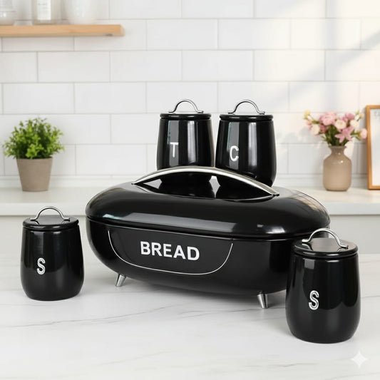 Black oval bread storage bin with three matching kitchen canisters