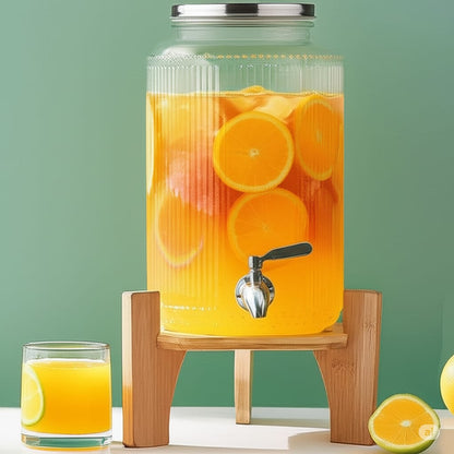 6L Ribbed glass juice dispenser with bamboo stand for serving beverages.