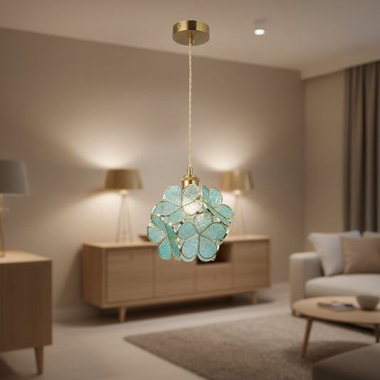 Floral pendant light with gold frame and blue green textured glass creating artistic ambient lighting