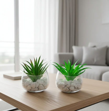 Glass vase with lifelike succulent plant for décor.