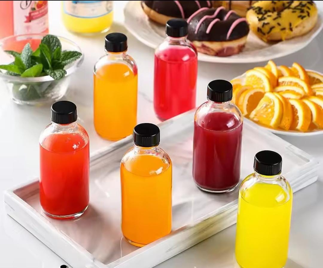 Set of five 60 ml glass gingershot bottles with black lids and a funnel.