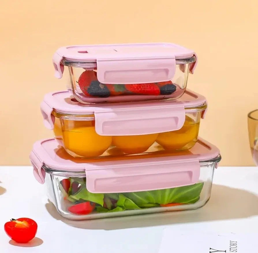 Glasslock food storage containers in pink and green with airtight lids.