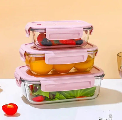 Glasslock food storage containers in pink and green with airtight lids.