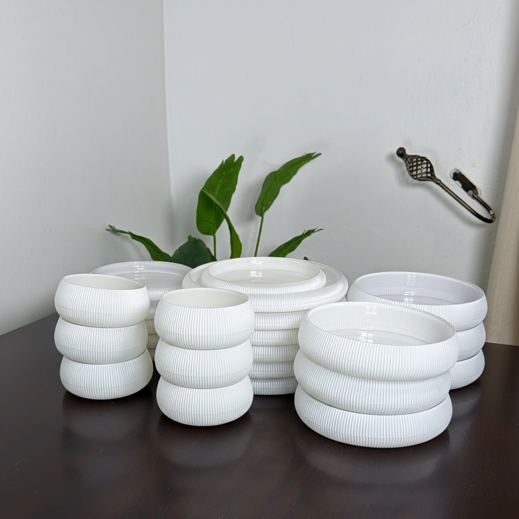 24 piece ribbed frosted glass dinner set with matching plates and bowls.
