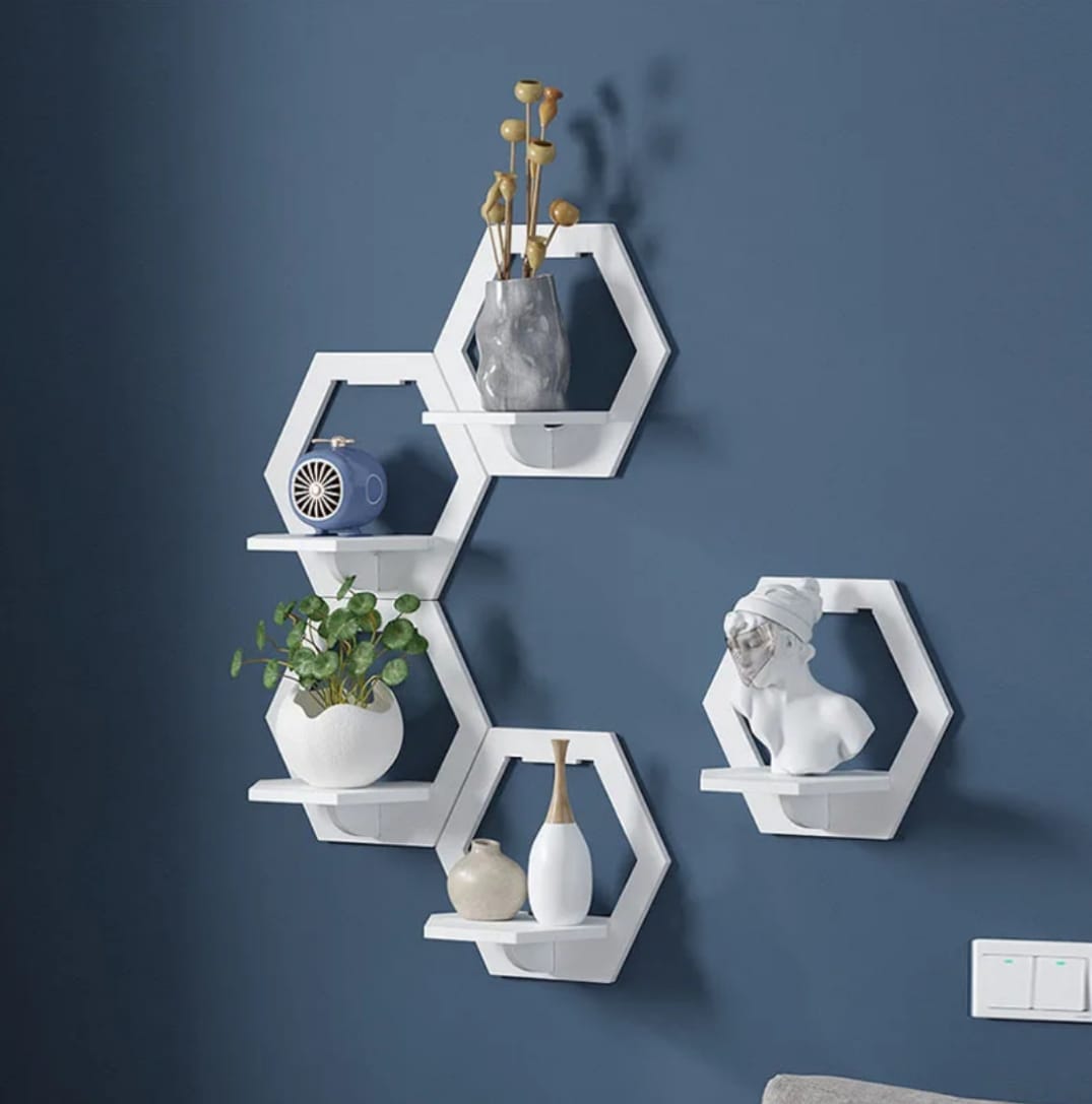 Set of three hexagon-shaped wall-mounted floating shelves.