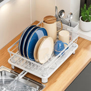 Minimalist white coated metal dish drying rack with utensil holder and drainage spout for kitchen organization