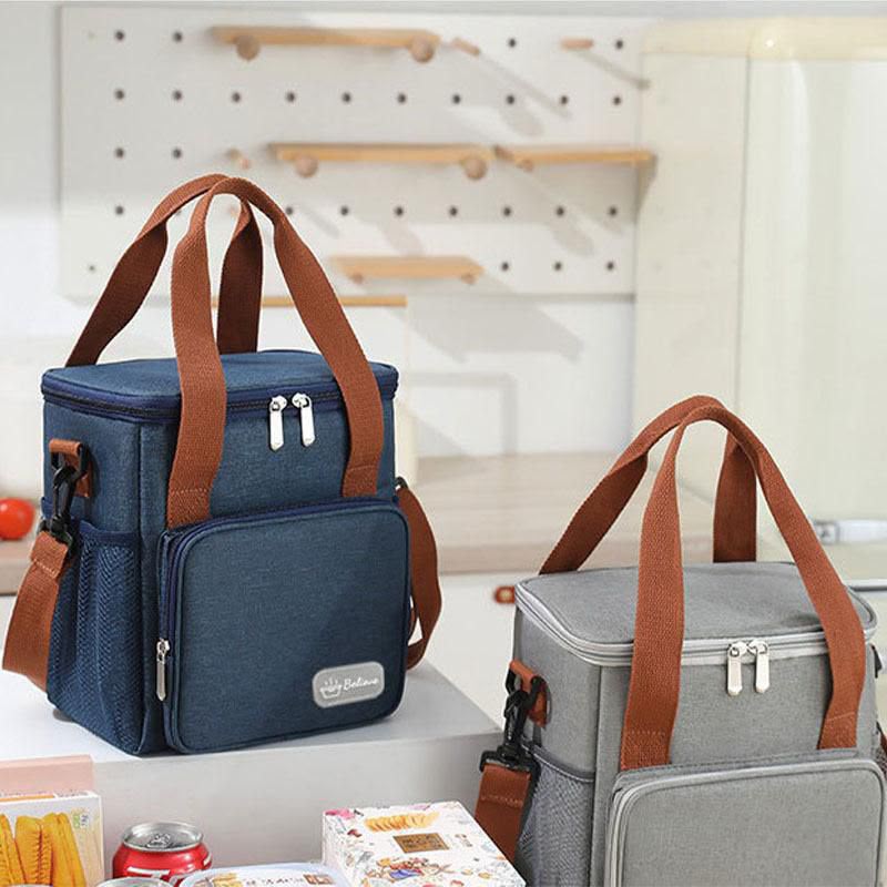 Insulated lunch bag with high density polyester exterior and leak resistant PEVA lining, available in black, brown, grey, and blue.