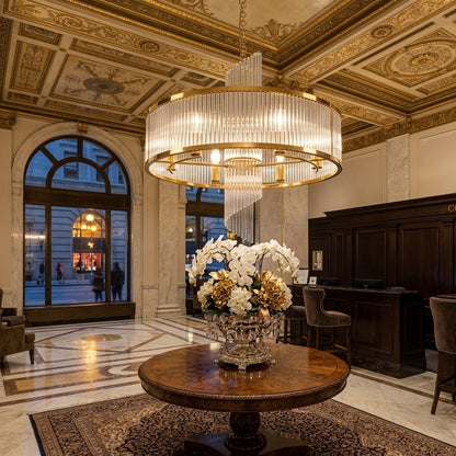 Modern gold crystal waterfall chandelier with dual layer circular design and cascading glass rods for luxury ceiling lighting. 