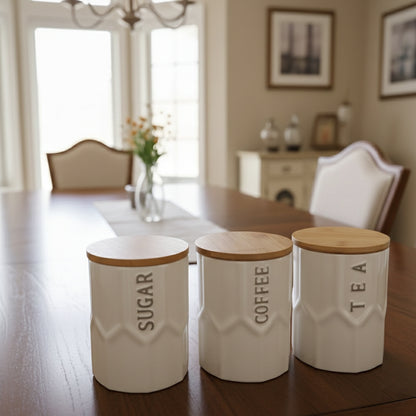 Three ceramic kitchen canisters with airtight lids arranged on a bamboo tray.