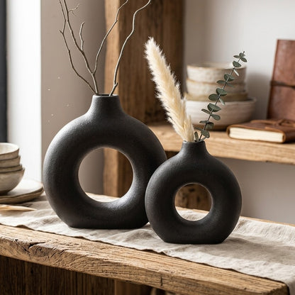 Black porcelain ceramic donut flower vase with modern artistic decorative design. 