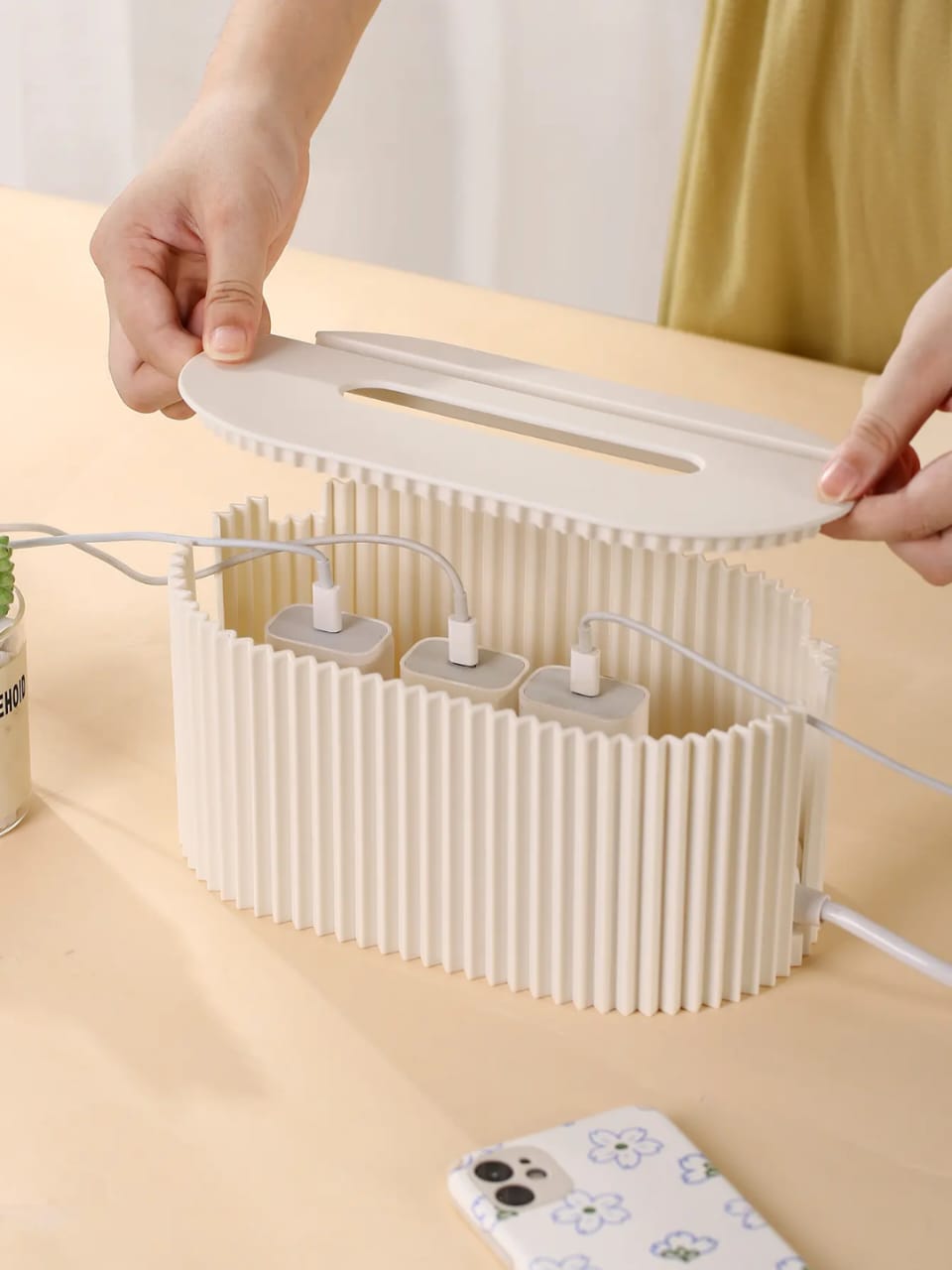 Electrical cable organizer box in grey and cream for hiding power strips and cords.