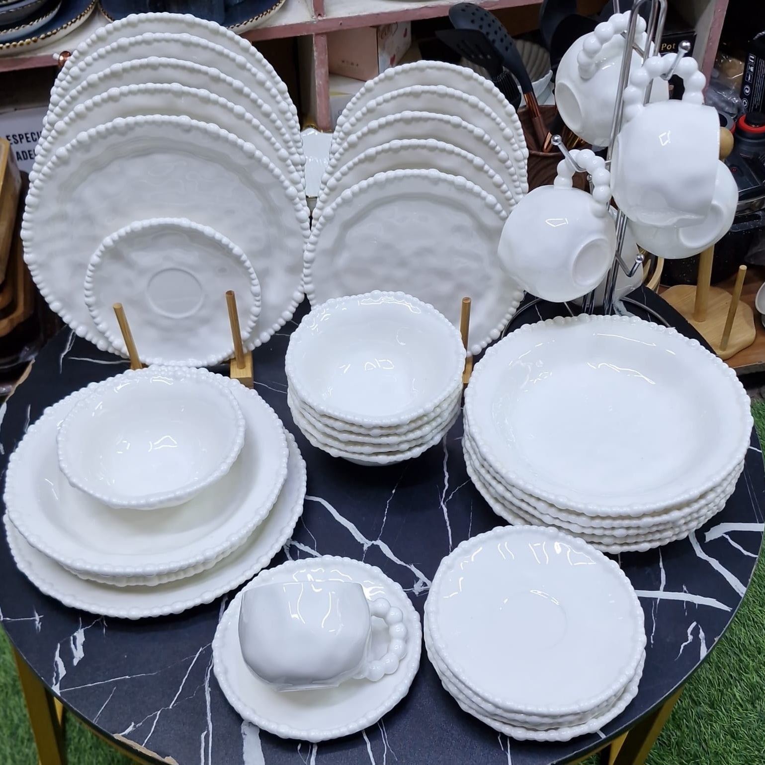 36 piece white ceramic dinnerware set with a glossy finish and elegant pearl rim, including dinner plates, side plates, bowls, cups, and saucers.