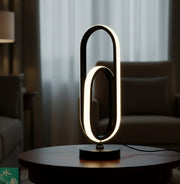 U-shaped modern LED table lamp with double-loop black design