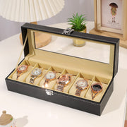 Leather watch organizer with six slots, transparent display lid, and lock for secure watch storage and display.