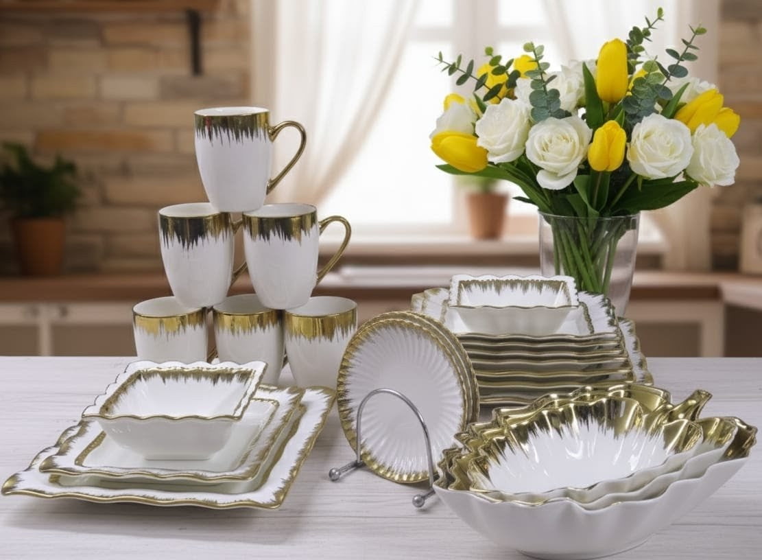 33 piece white ceramic dinner set with gold detailing, including plates, bowls, mugs, saucers, and leaf serving bowls