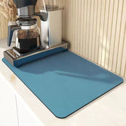 High absorbent dish draining mat on kitchen countertop for drying dishes.