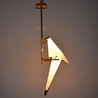Metal bird shape tabletop lamp with decorative design.