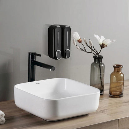 Wall-mounted manual press soap dispenser in black and white for bathroom use