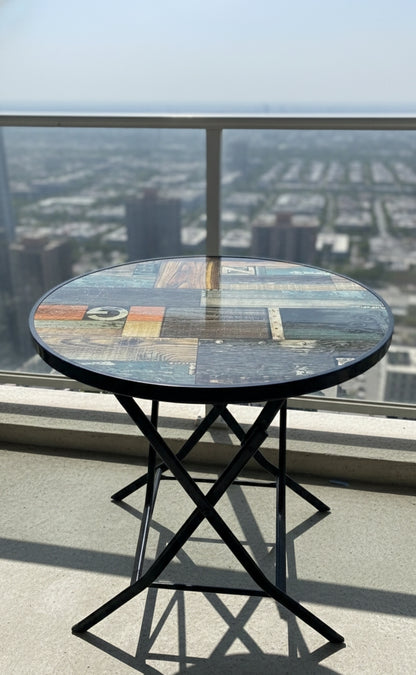 Foldable round accent table, portable and modern design.