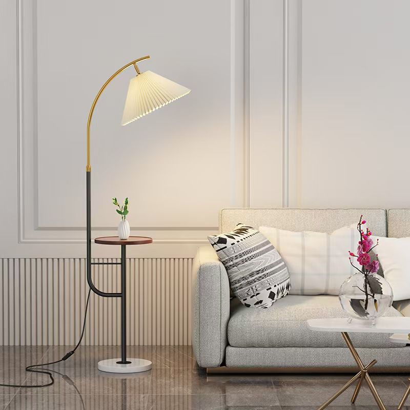 Elegant black and gold arc floor lamp with built in side table and pleated shade