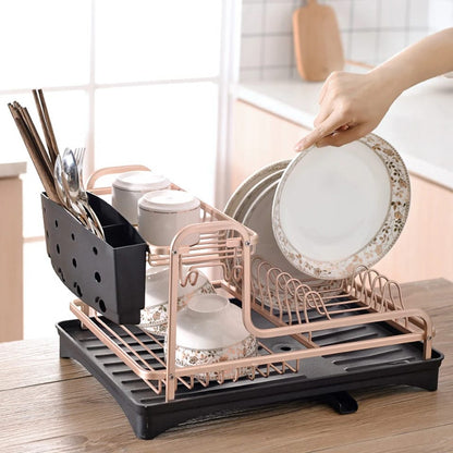 Gold aluminum kitchen dish drying rack with drainer plate and cutlery holder.