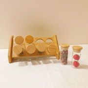 8 Clear spice jars with a bamboo stand displayed together.