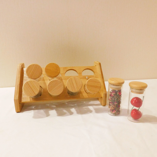 8 Clear spice jars with a bamboo stand displayed together.