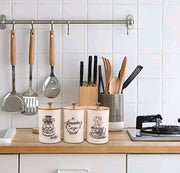 Set of cream white airtight metal canisters for sugar, tea, and coffee