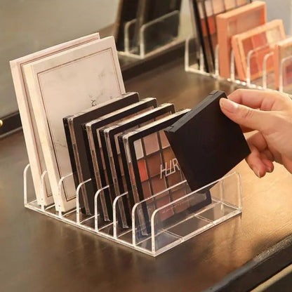 Clear acrylic 7 grid eyeshadow palette organizer display tray for makeup storage.
