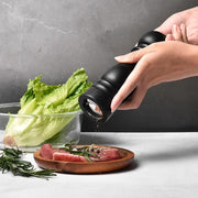 6-inch wooden pepper grinder with adjustable stainless steel mill, black finish, for fine or coarse seasoning. 