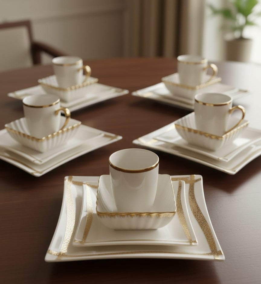 Porcelain twenty four piece gold line dinner set with cups, plates, and bowls