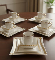 Porcelain twenty four piece gold line dinner set with cups, plates, and bowls