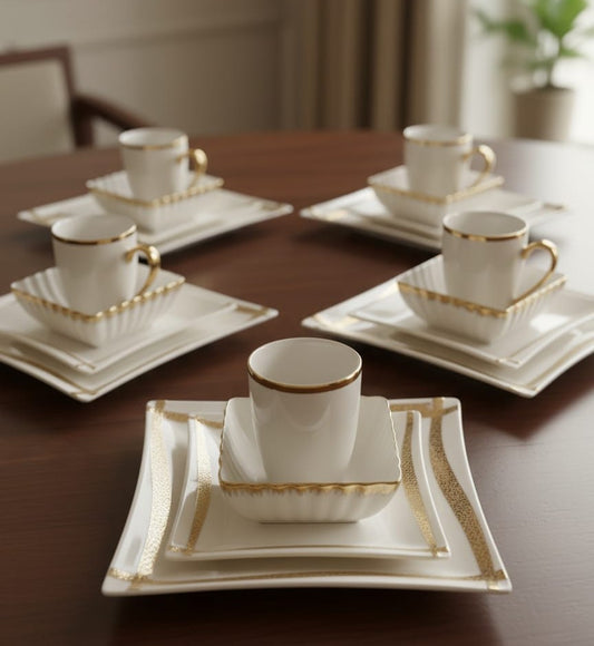 Porcelain twenty four piece gold line dinner set with cups, plates, and bowls
