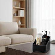 Multi-compartment leather desk organizer for remotes and office accessories.