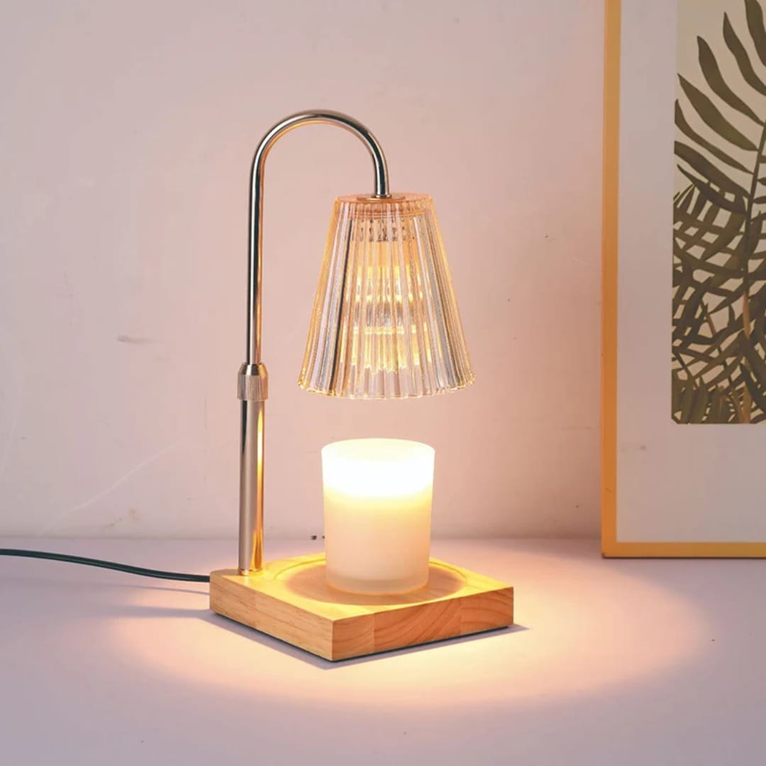 Electric candle warmer with glass body and wooden base, includes two bulbs for melting scented candles safely. 
