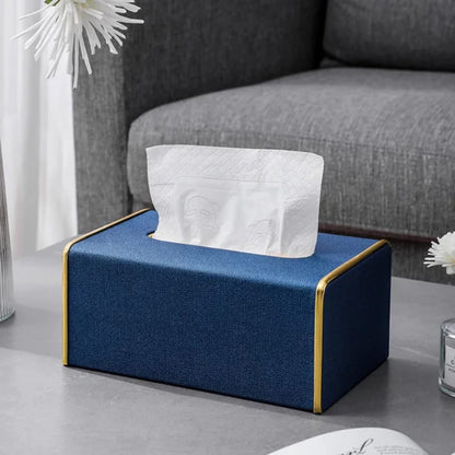 Grey fabric tissue holder with gold trim accents, elegant serviette box with non-slip base for home or office. 
