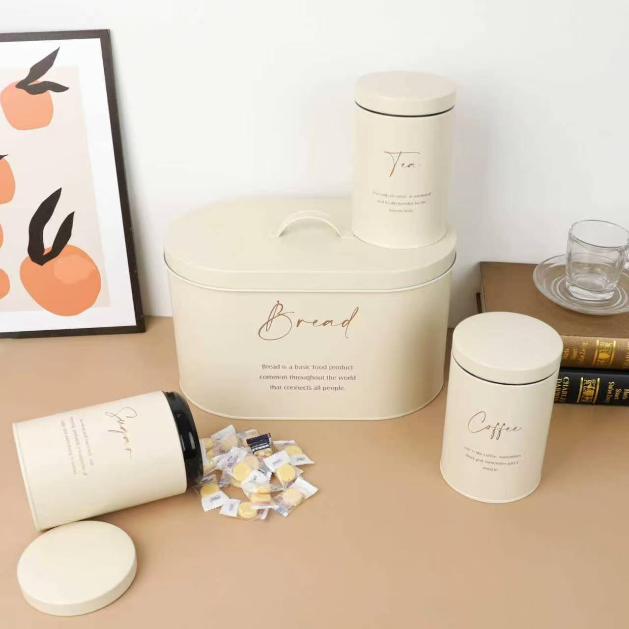 4 piece quilted metal kitchen storage set with bread box and labelled coffee, sugar, and tea canisters with airtight lids.