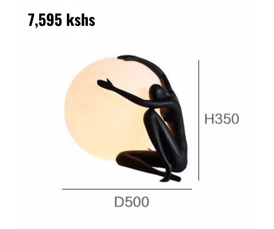 Dawood Lifestyle & Gadgets kes modern abstract figure globe lamp in matte black with frosted LED globe, sculptural resin design, and warm ambient lighting for luxury home and office décor.