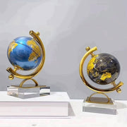 Dawood Lifestyle & Gadgets kes rotating world globe decor with gold meridian frame and clear crystal base, available in ocean blue and midnight black finishes.