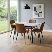 Four-seater marble dining table with microfiber chairs and metallic black legs with gold finish