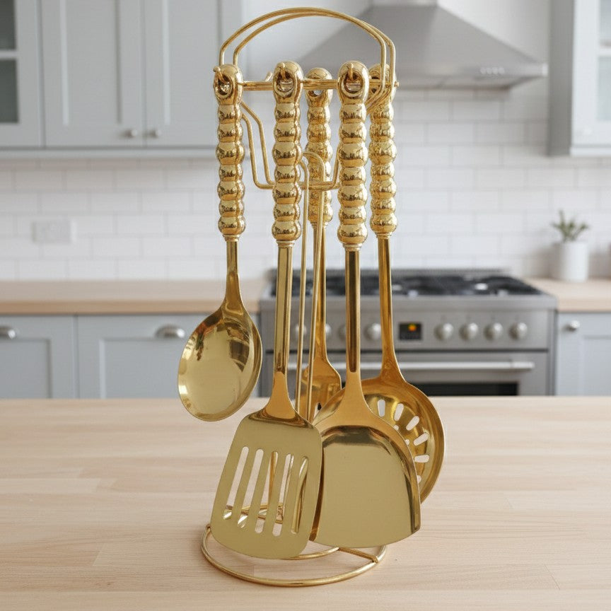 6-in-1 Gold serving spoon set with ceramic handles and stand.