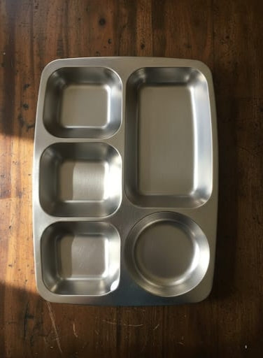 Silver stainless steel plate with five food compartments.