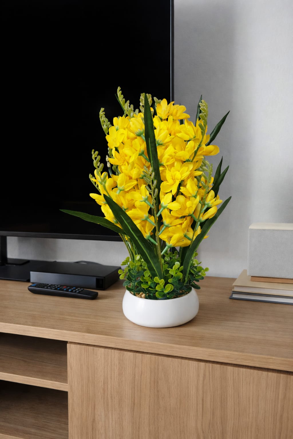 Table top decorative potted flowers in yellow, orange, and white