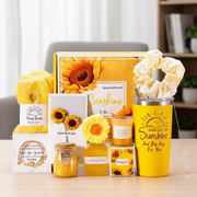 Valentines gift set with insulated mug, bracelet, fuzzy socks, scented candles, skincare items, hairband, gift bag, and sunflower gift card.
