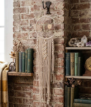 Macrame wall hanging dreamcatcher with owl charm, bohemian decorative piece for bedroom or living room walls. 