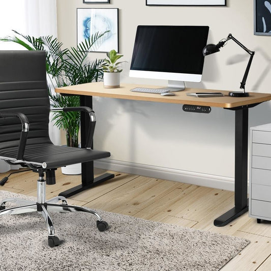 Electric adjustable height office desk in white, black, and light brown colors.